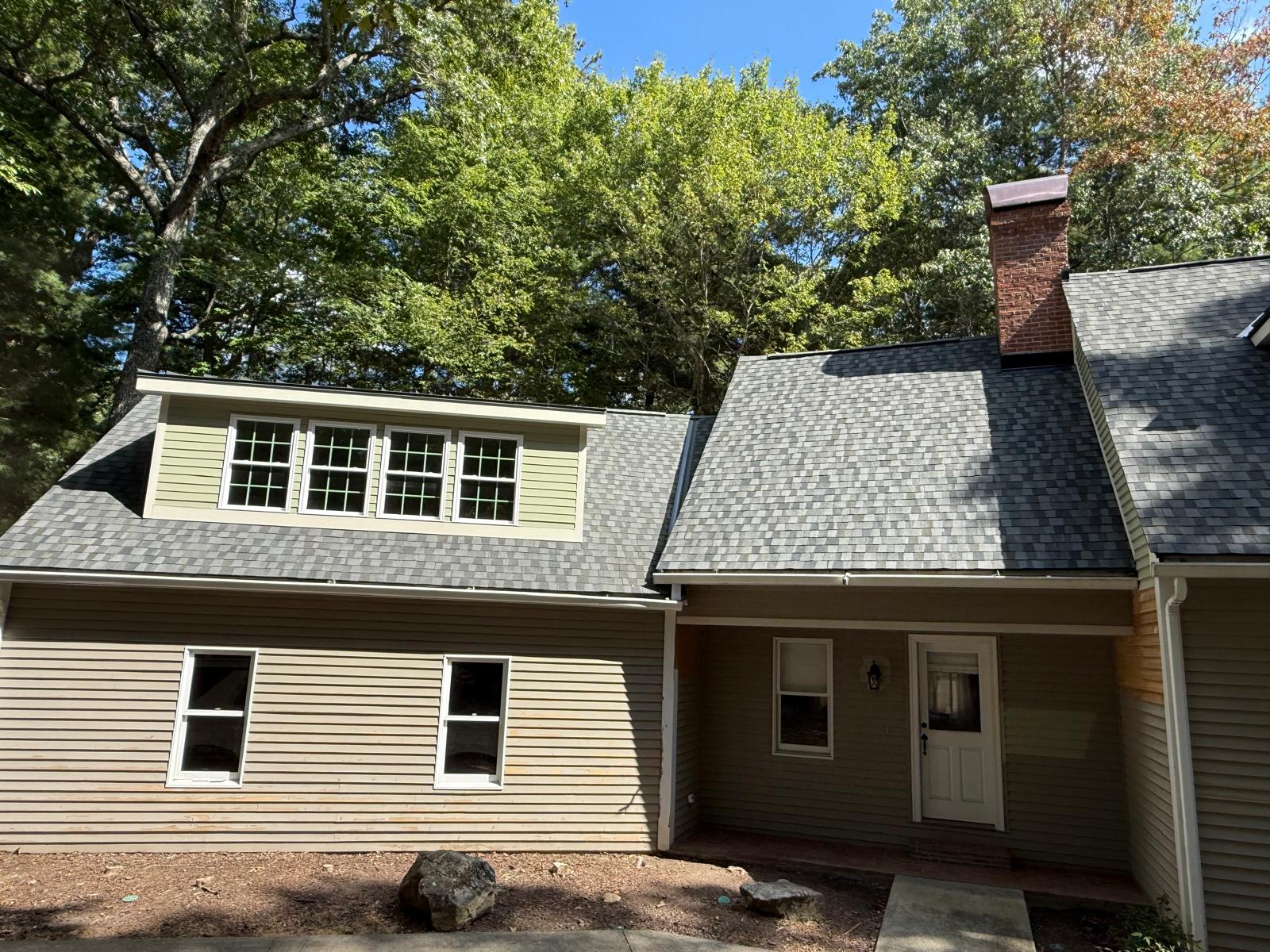 Custom home with a newly completed shingle roofing system