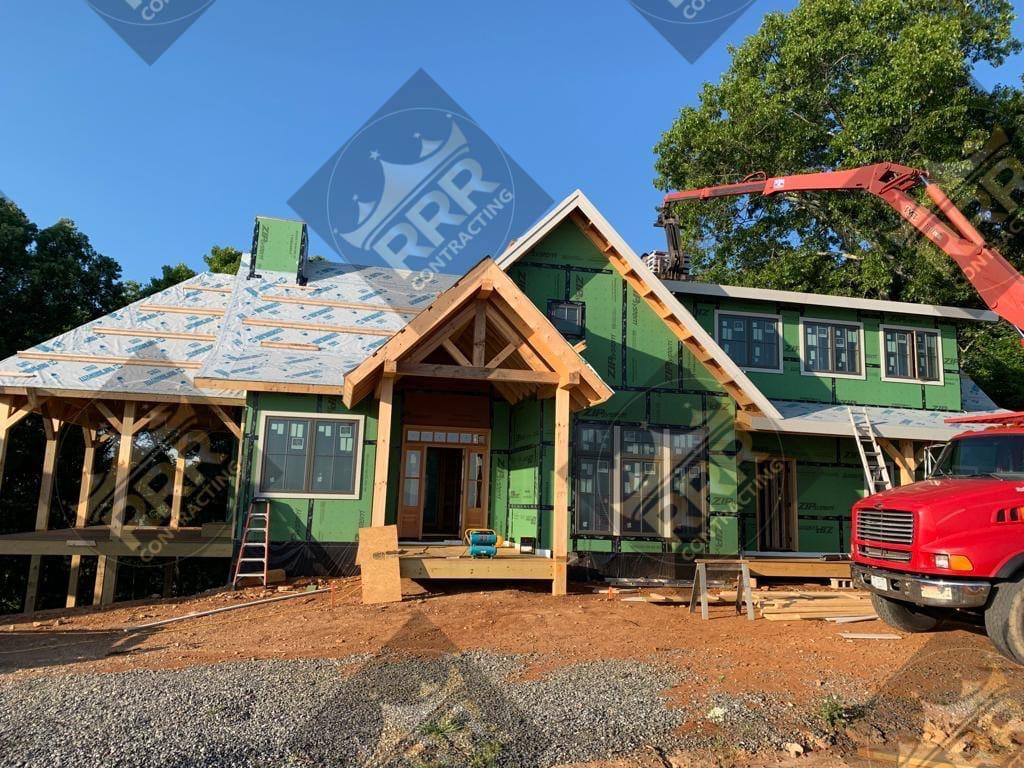 New residential construction with roof framing and sheathing underway