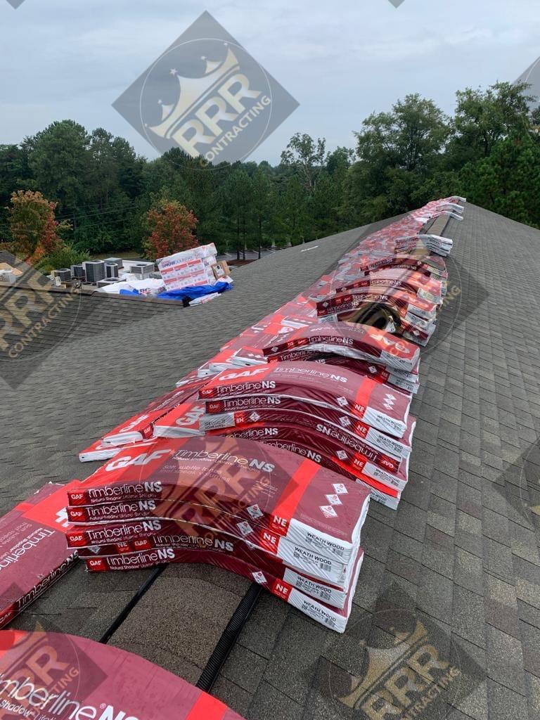 Premium GAF Timberline shingle bundles staged on a roof, ready for installation