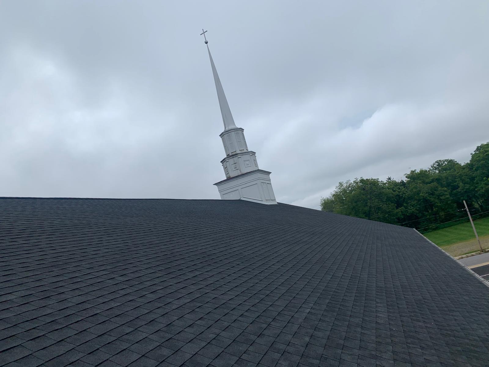 Large-scale shingle roofing project on a commercial building
