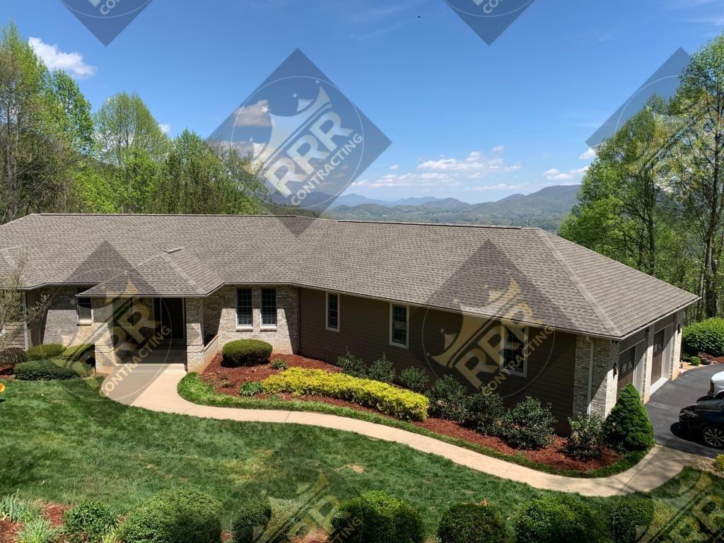 Aerial view of a residential roof and property in Western North Carolina