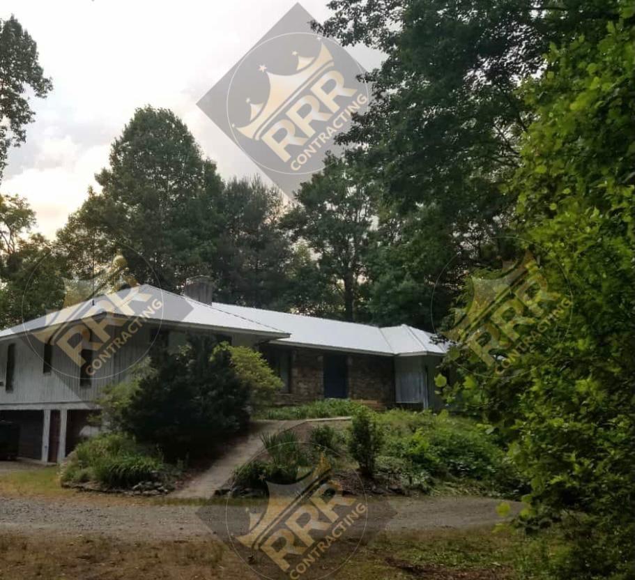 White standing seam metal roof installed on a residential home
