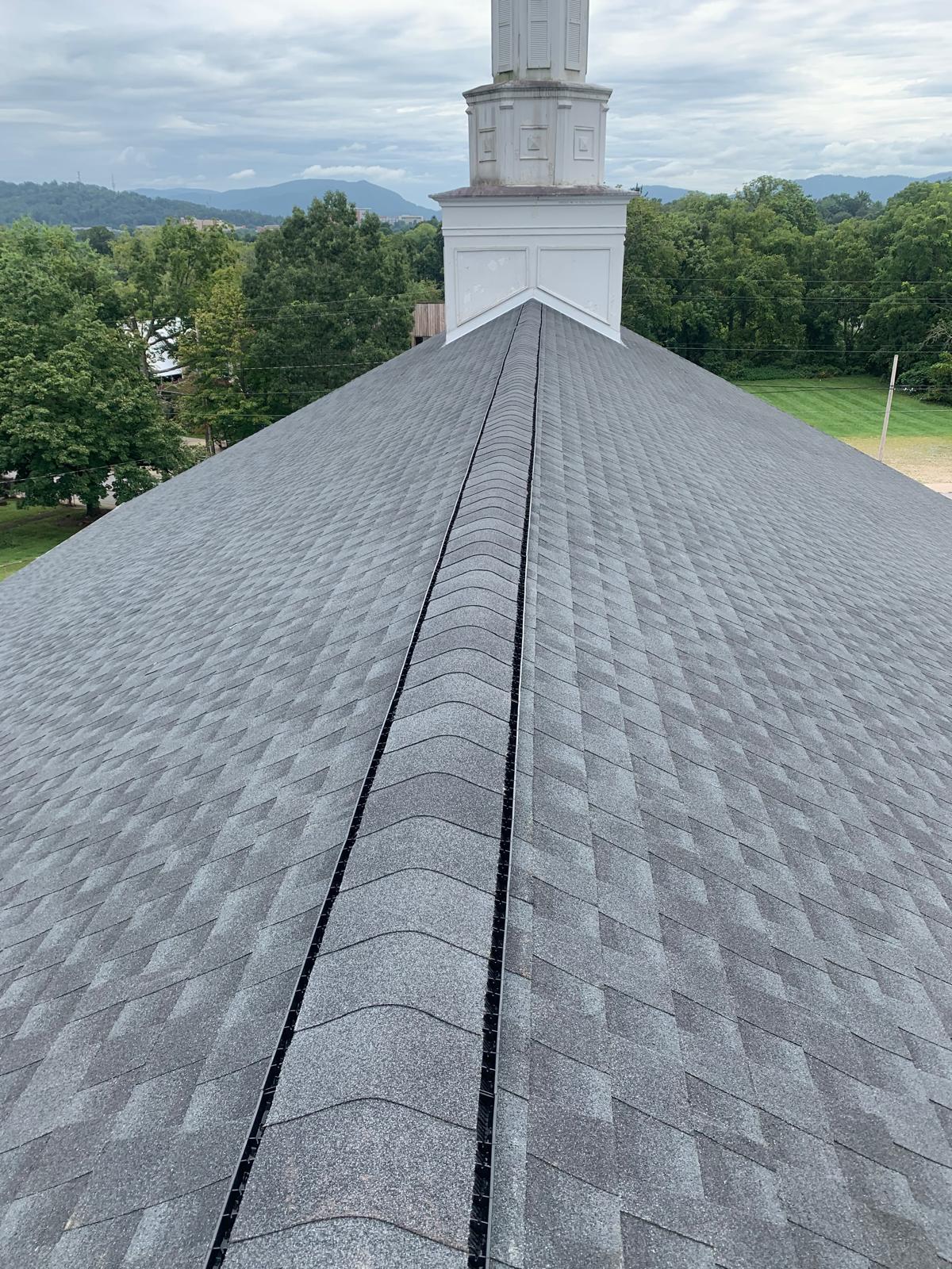 Completed full roof replacement with a scenic mountain backdrop